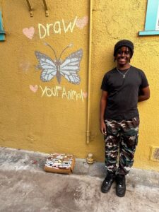 Our talented high school intern bringing beauty to the sidewalk and alley.